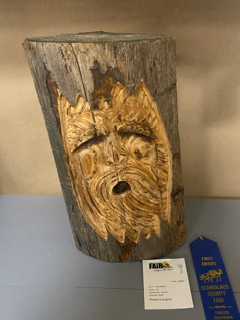 Stump carved with screaming man.
